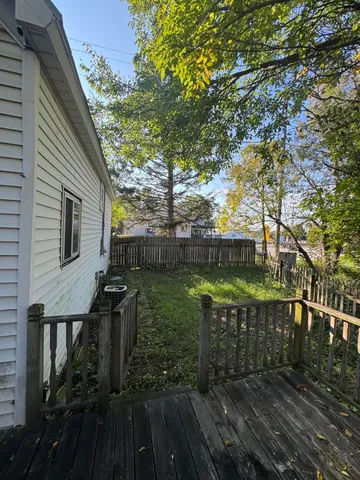 a view of a balcony with wooden floor
