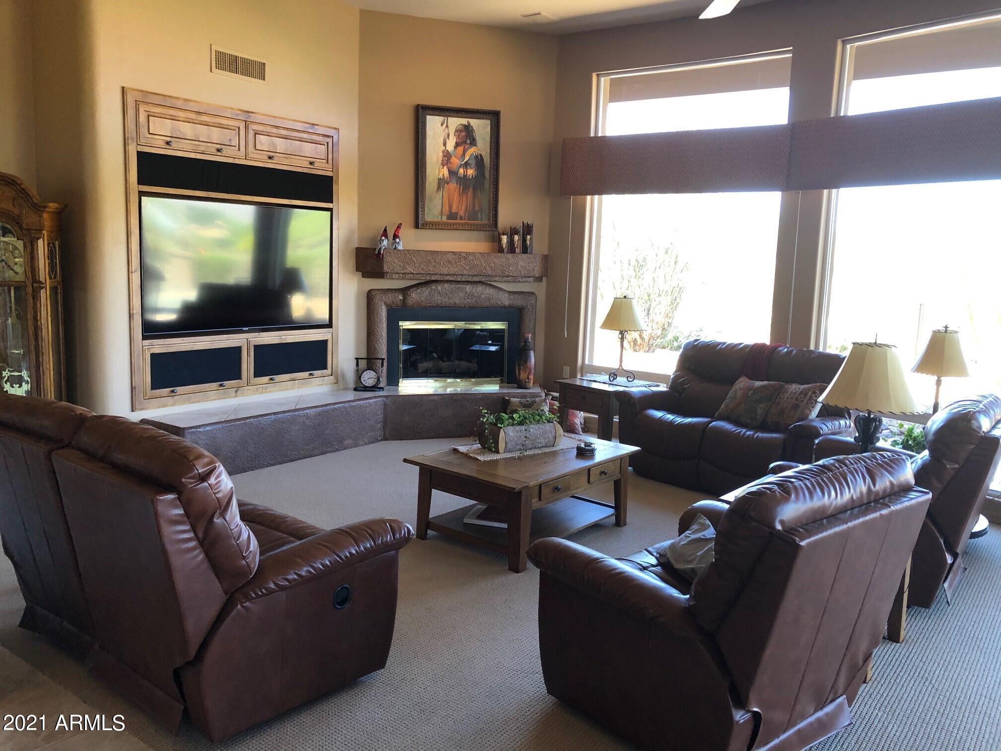 18502 East Picacho Road Rio Verde, AZ 85263 - Photo 7 of 15 a living room with furniture a flat screen tv and a fireplace
