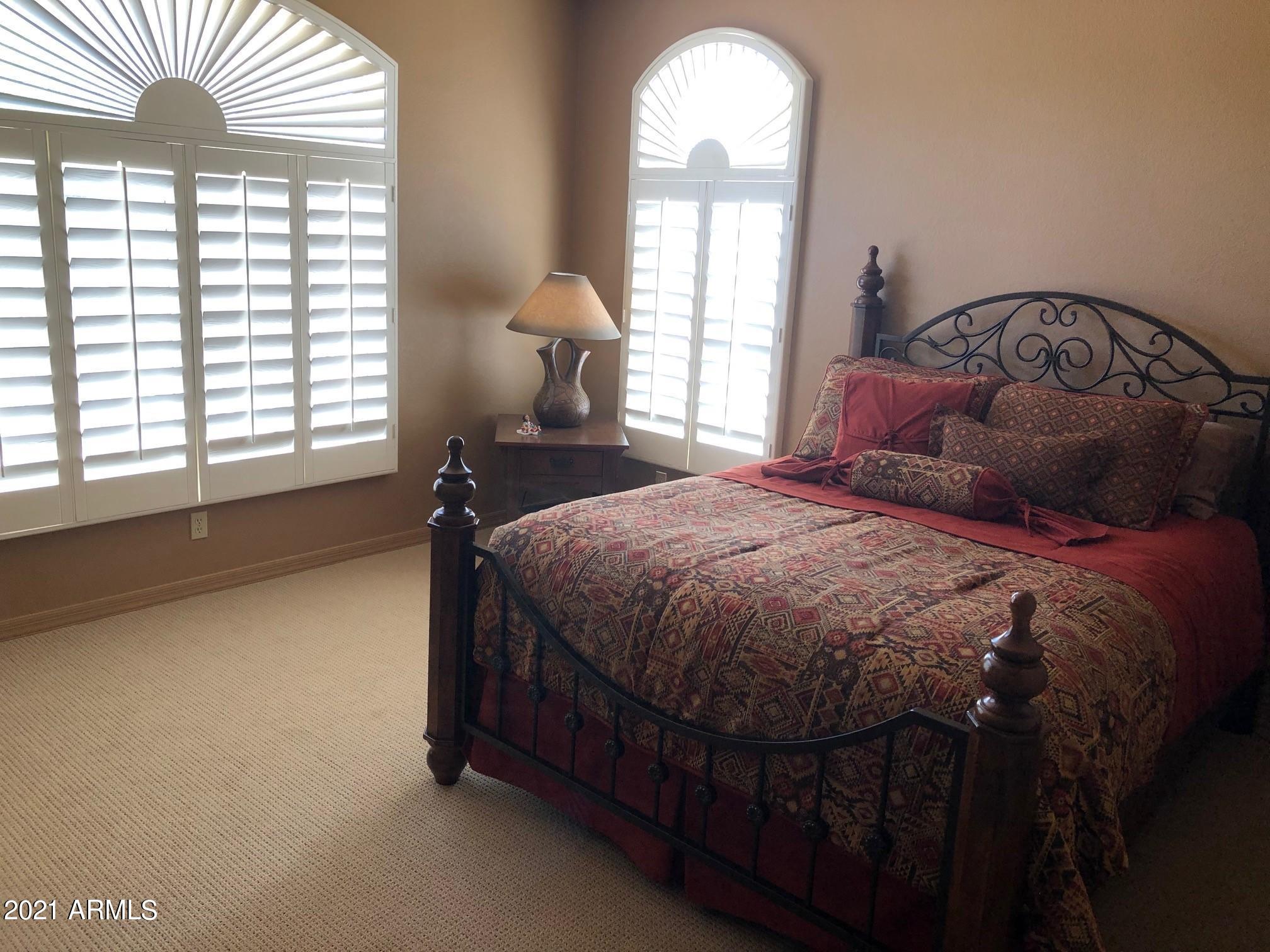 18502 East Picacho Road Rio Verde, AZ 85263 - Photo 10 of 15 a bed sitting in a bedroom next to a window