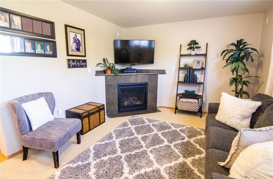 2311 Cedar Road Lake Stevens, WA 98258 - Photo 12 of 37 a living room with furniture a flat screen tv and a fireplace
