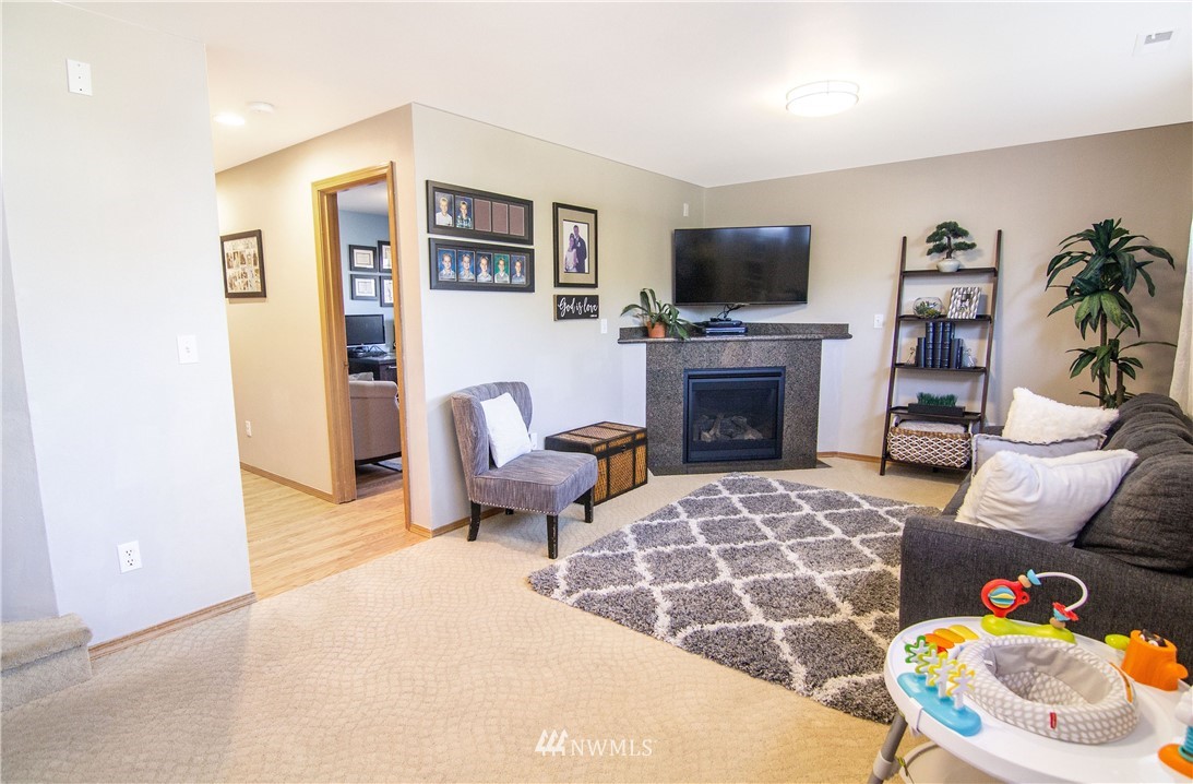 2311 Cedar Road Lake Stevens, WA 98258 - Photo 13 of 37 a living room with furniture flat screen tv and a fireplace