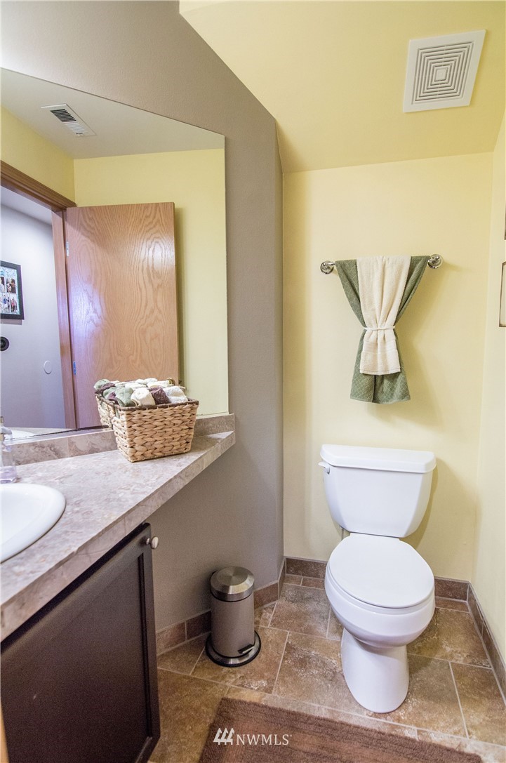 2311 Cedar Road Lake Stevens, WA 98258 - Photo 16 of 37 a bathroom with a granite countertop toilet and a sink