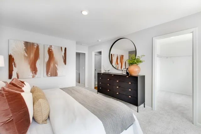 a bedroom with a bed and a dresser