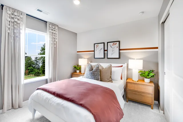 a bedroom with a bed and a painting on the wall