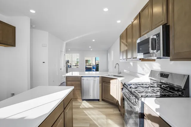 a kitchen with a sink stove and microwave