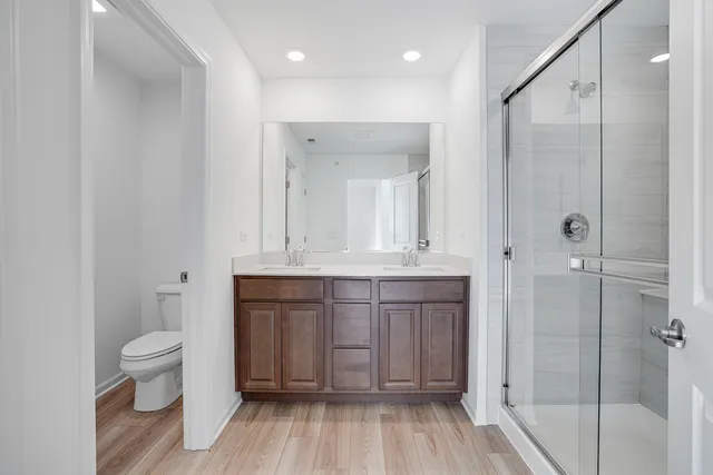 a bathroom with a sink a toilet and shower