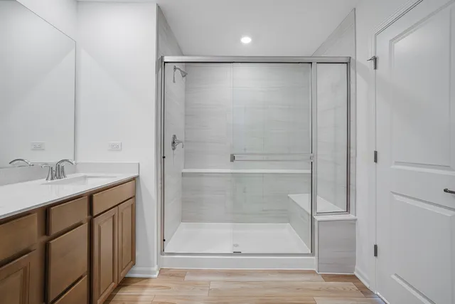 a bathroom with a shower sink and mirror