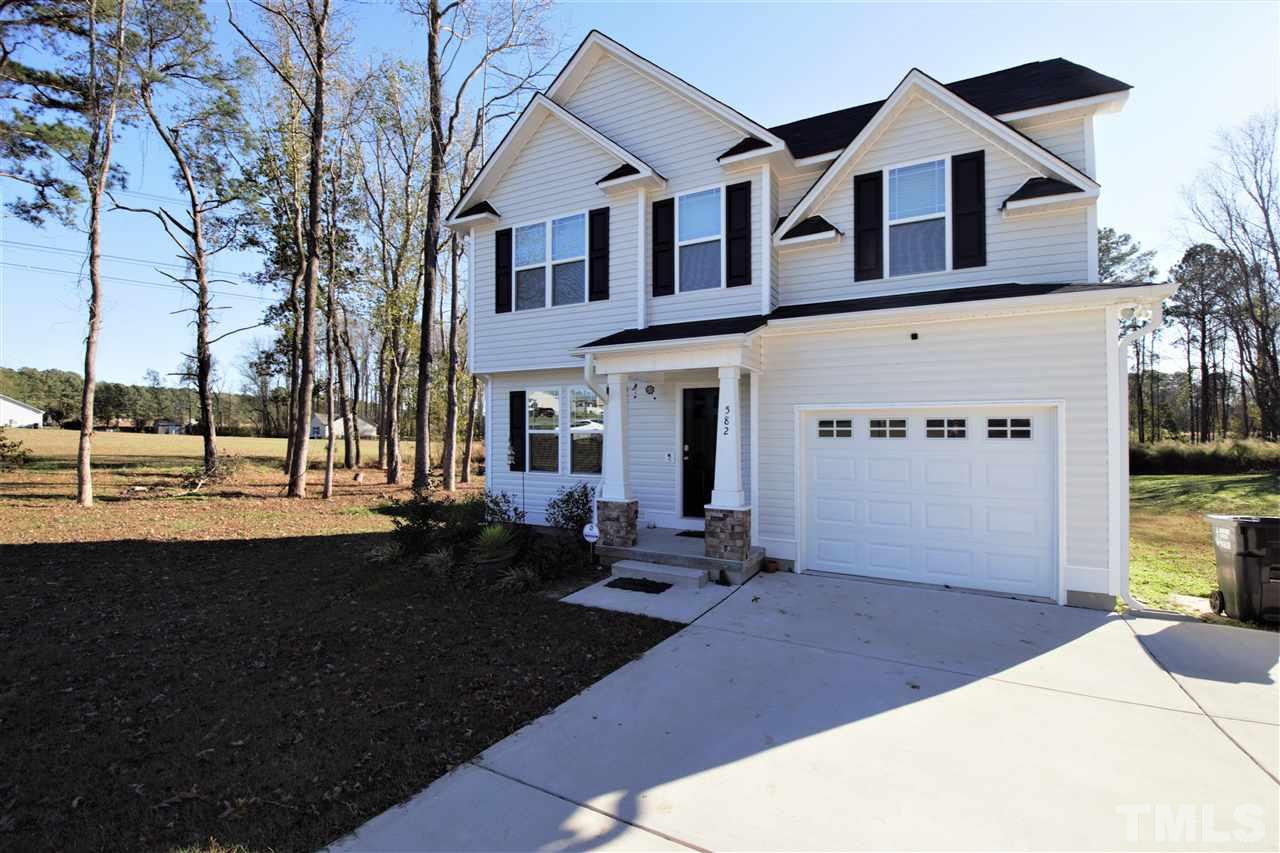 582 Roberts Road Willow Spring, NC 27592 - Photo 1 of 17 a front view of a house with garden