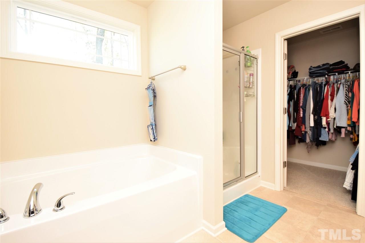 582 Roberts Road Willow Spring, NC 27592 - Photo 11 of 17 a view of walk in closet with clothes and shoes