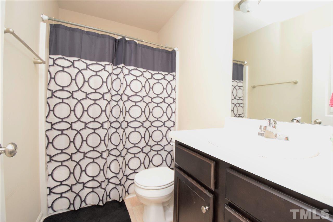582 Roberts Road Willow Spring, NC 27592 - Photo 16 of 17 a bathroom with a sink a toilet and a mirror