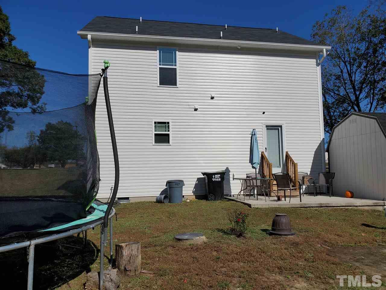 582 Roberts Road Willow Spring, NC 27592 - Photo 17 of 17 a view of a house with backyard and sitting area