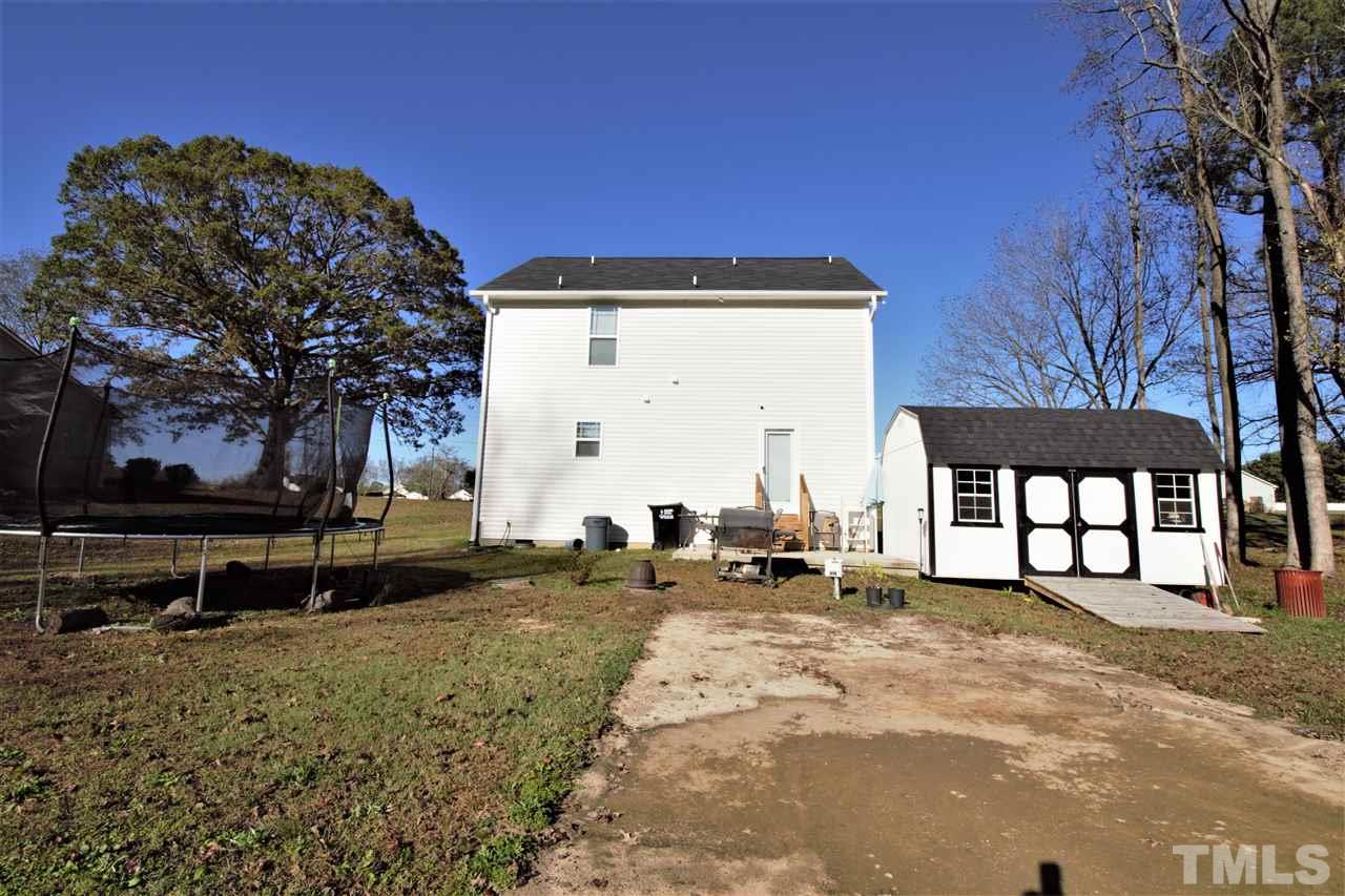 582 Roberts Road Willow Spring, NC 27592 - Photo 4 of 17 a view of a house with backyard and sitting area