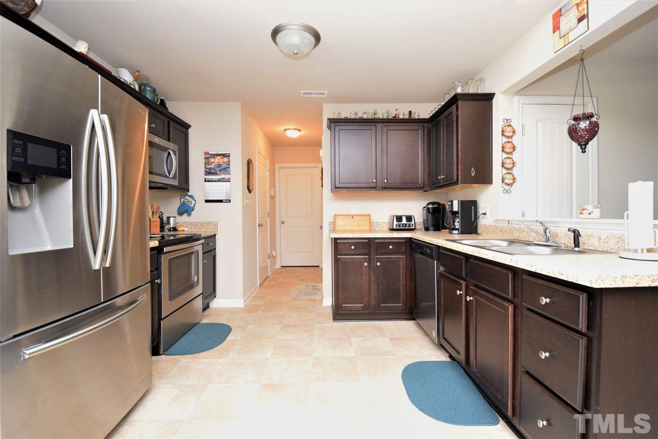 582 Roberts Road Willow Spring, NC 27592 - Photo 6 of 17 a kitchen with stainless steel appliances granite countertop a sink refrigerator and cabinets