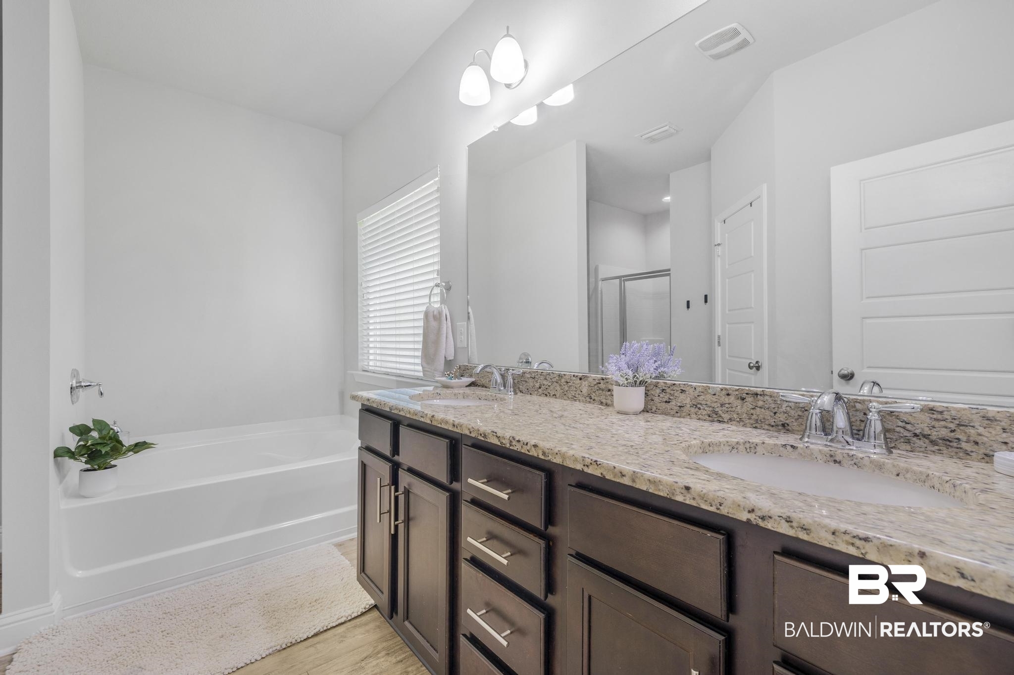 31336 Hoot Owl Road Daphne, AL 36527 - Photo 12 of 36 Full bathroom with a bath, double vanity, a shower stall, and light wood-type flooring