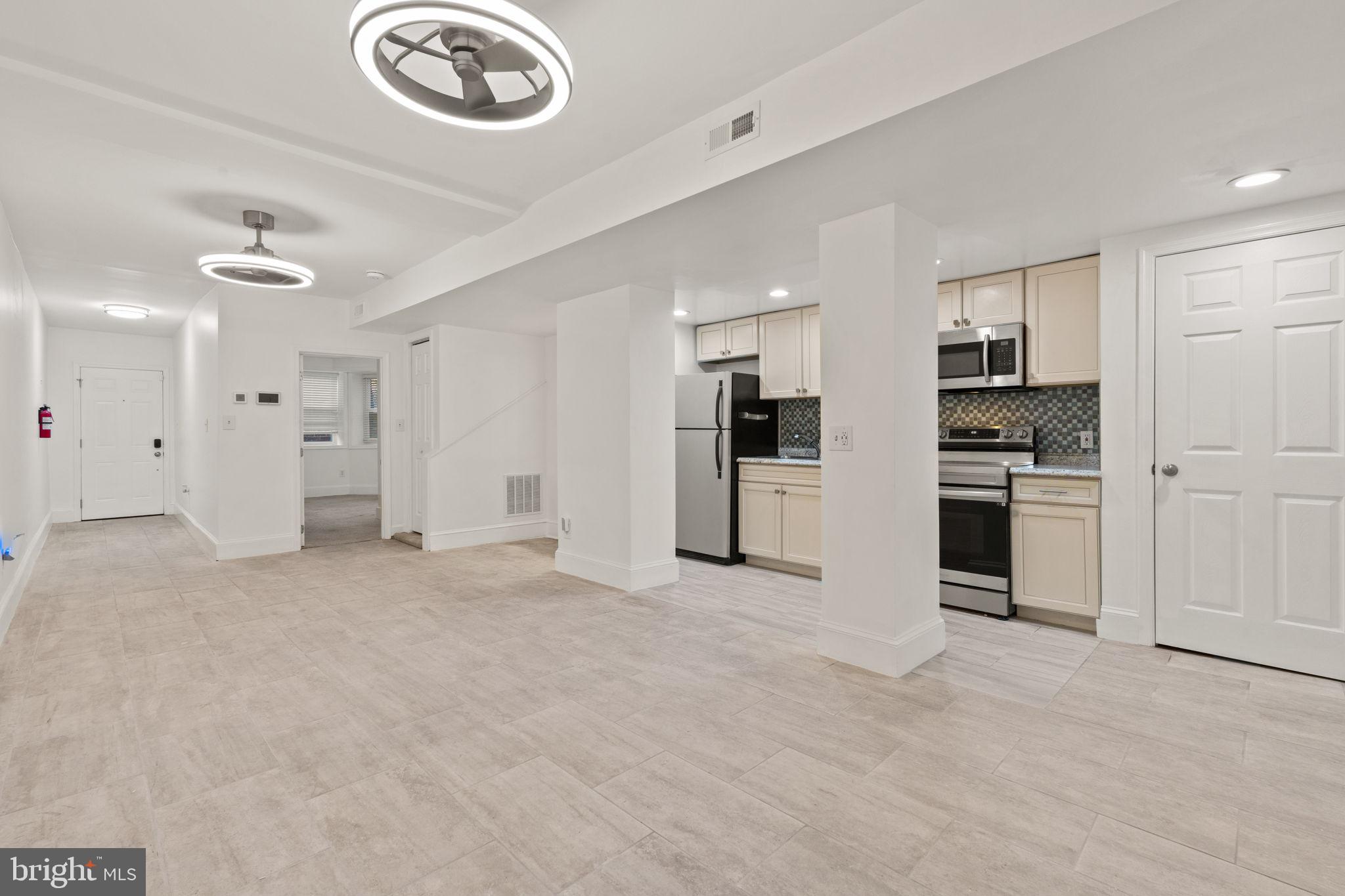 1308 Park Road Northwest, Unit 2 Washington, DC 20010 - Photo 3 of 17 a view of a kitchen with a sink and a refrigerator
