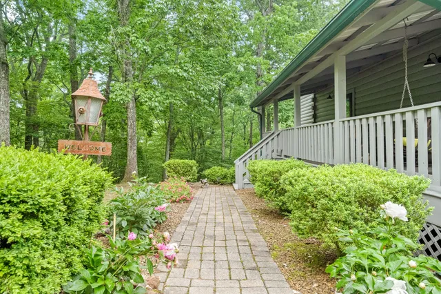 a living room with couches bookshelf and a flat screen tv