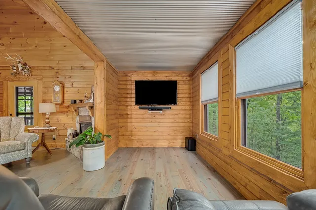 a bedroom with a bed furniture and a flat screen tv