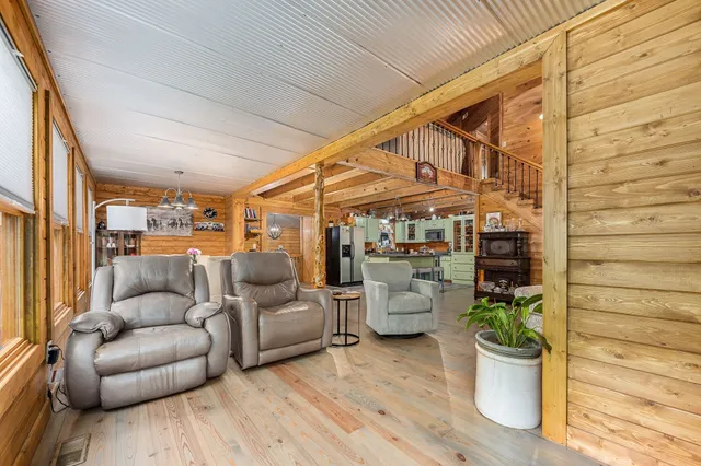 a room with stainless steel appliances kitchen island granite countertop lots of counter top space