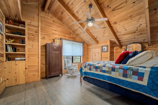 an aerial view of residential house with outdoor space and trees all around