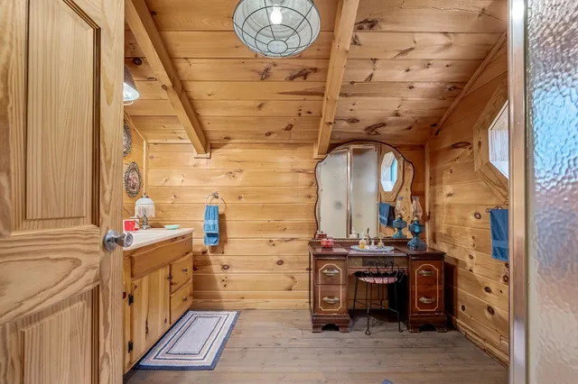 an aerial view of residential house with outdoor space and trees all around
