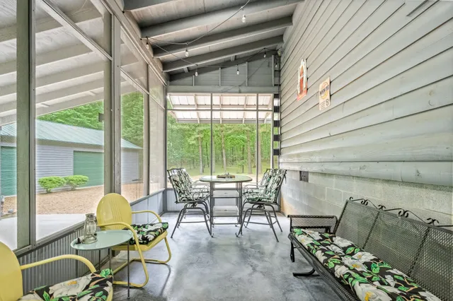 a view of a lush green forest with trees and some houses