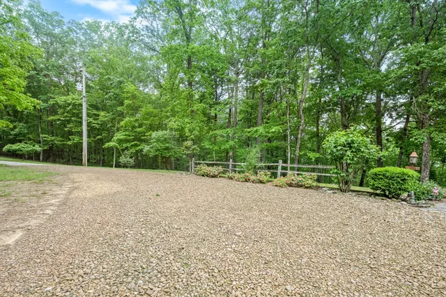 a front view of a house with a yard table and chairs