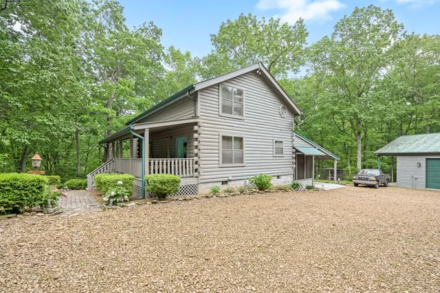 a living room with fireplace furniture and a floor to ceiling window