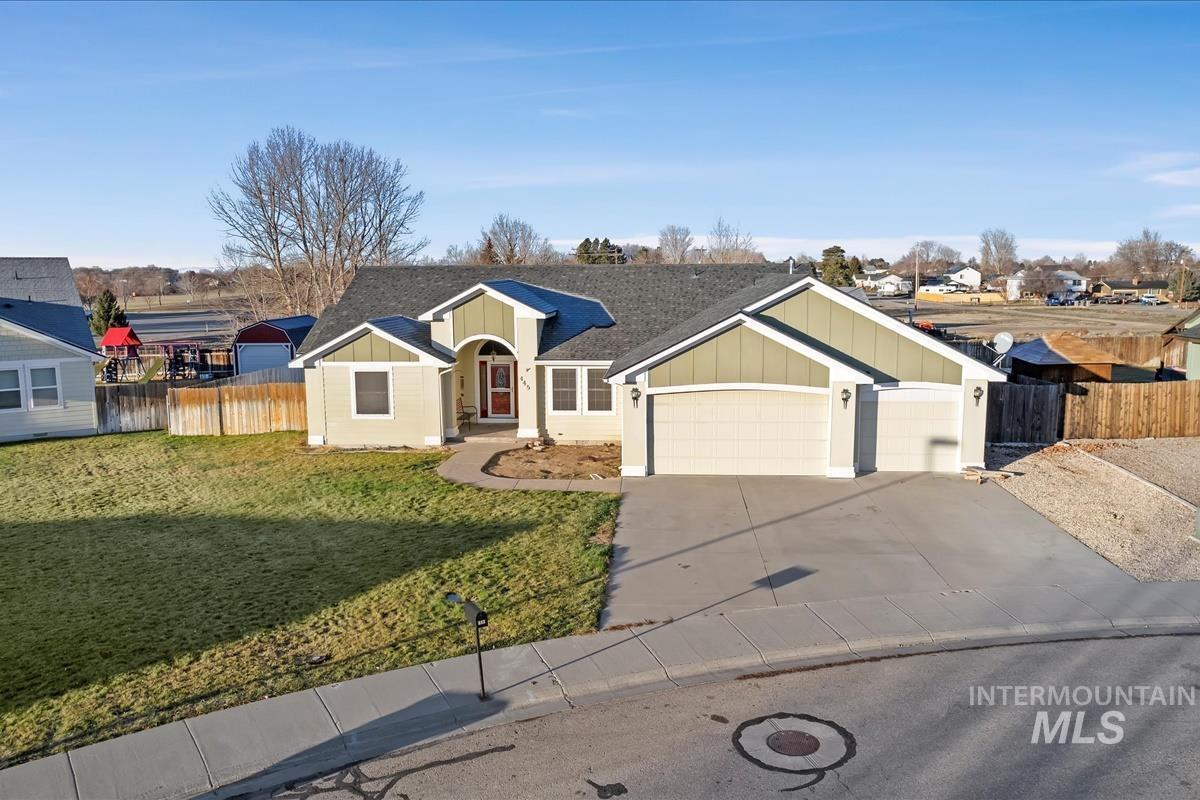 View of front of property featuring concrete driveway, roof with shingles, board and batten siding, and a garage