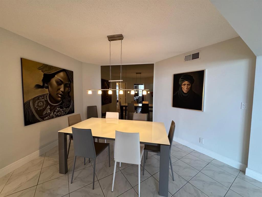 1340 South Ocean Boulevard, Unit 1109 Pompano Beach, FL 33062 - Photo 11 of 42 a view of a dining room and a table and chairs