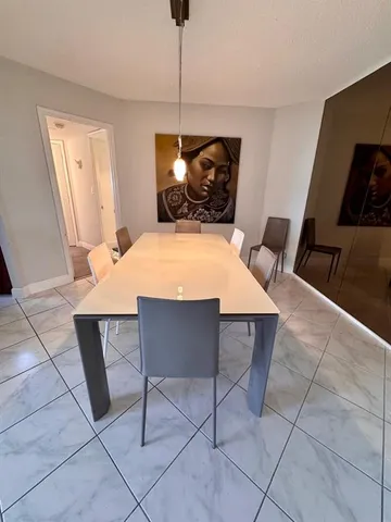 a dining room with a table and chairs