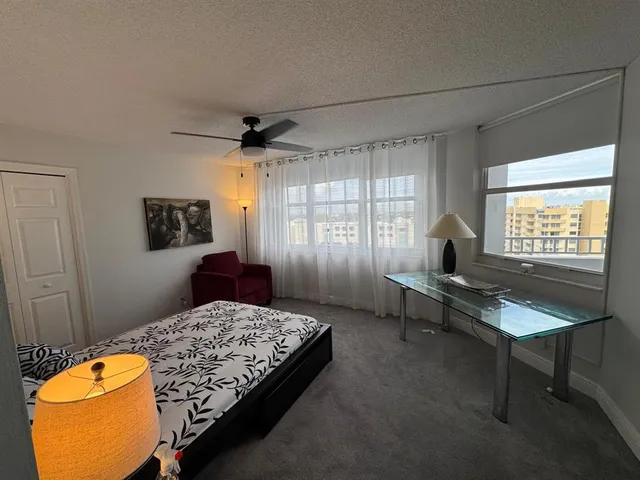 a living room with a bed furniture and a window