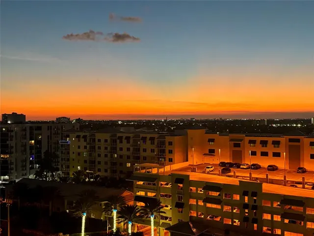 a view of a terrace with lawn chairs