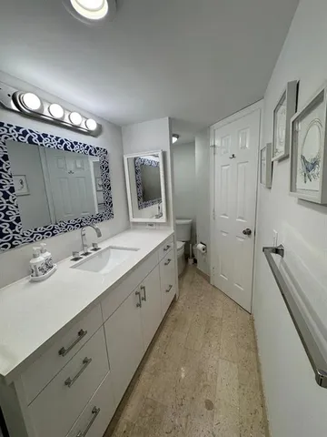 a spacious bathroom with a double vanity sink mirror and bathtub