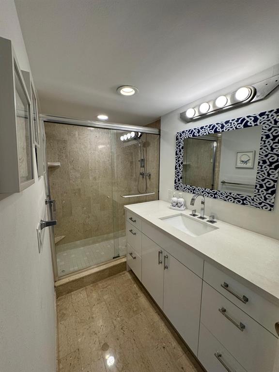 1340 South Ocean Boulevard, Unit 1109 Pompano Beach, FL 33062 - Photo 22 of 42 a bathroom with a double vanity sink mirror and shower