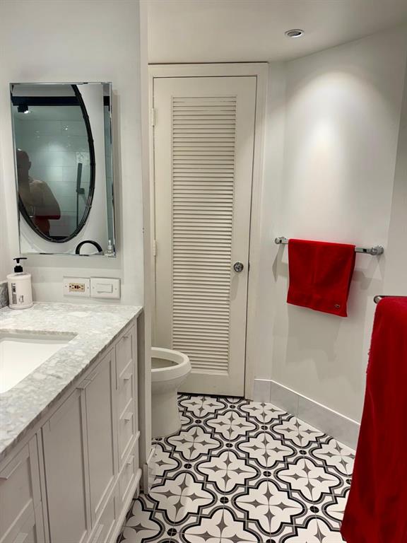 1340 South Ocean Boulevard, Unit 1109 Pompano Beach, FL 33062 - Photo 27 of 42 a bathroom with a granite countertop sink and a mirror