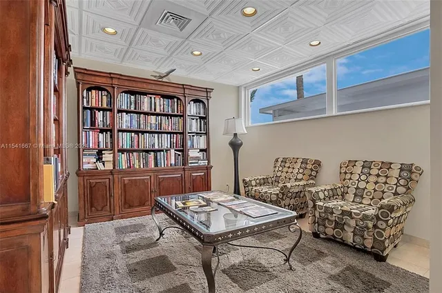 a view of a swimming pool with a lawn chairs and palm tree