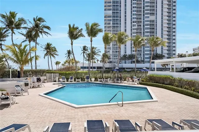 a living room with lots of furniture a table and a large window