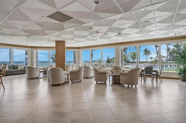 a dining room with furniture and a chandelier