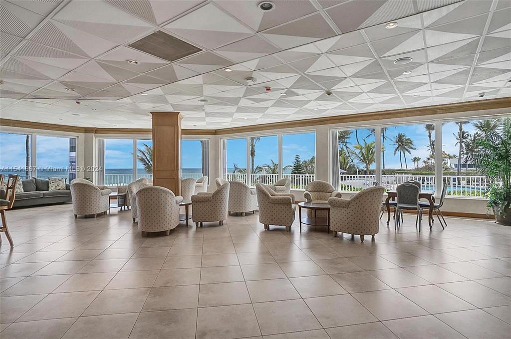 1340 South Ocean Boulevard, Unit 1109 Pompano Beach, FL 33062 - Photo 35 of 42 a living room with lots of furniture a table and a large window
