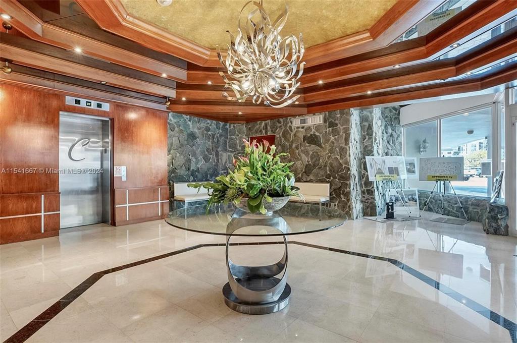 1340 South Ocean Boulevard, Unit 1109 Pompano Beach, FL 33062 - Photo 36 of 42 a dining room with furniture and a chandelier