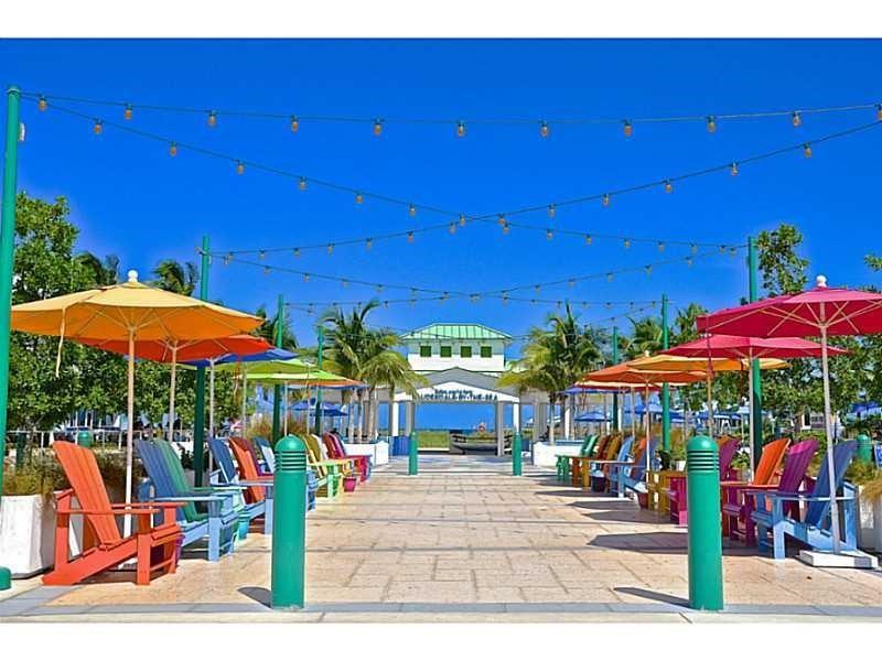 1340 South Ocean Boulevard, Unit 1109 Pompano Beach, FL 33062 - Photo 40 of 42 a view of a patio with chairs and umbrellas