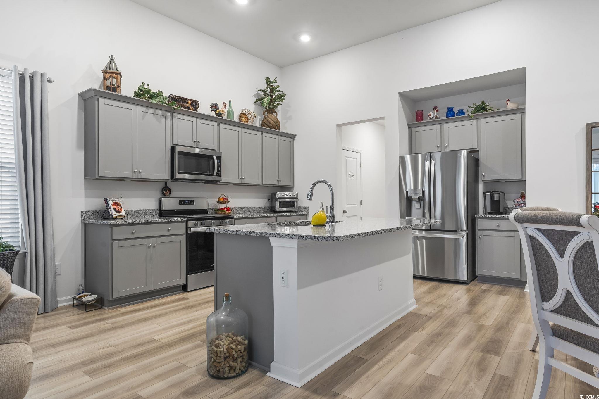 394 Sun Colony Boulevard Longs, SC 29568 - Photo 11 of 37 Modern kitchen with granite countertops, ample cabinetry, and stainless steel appliances