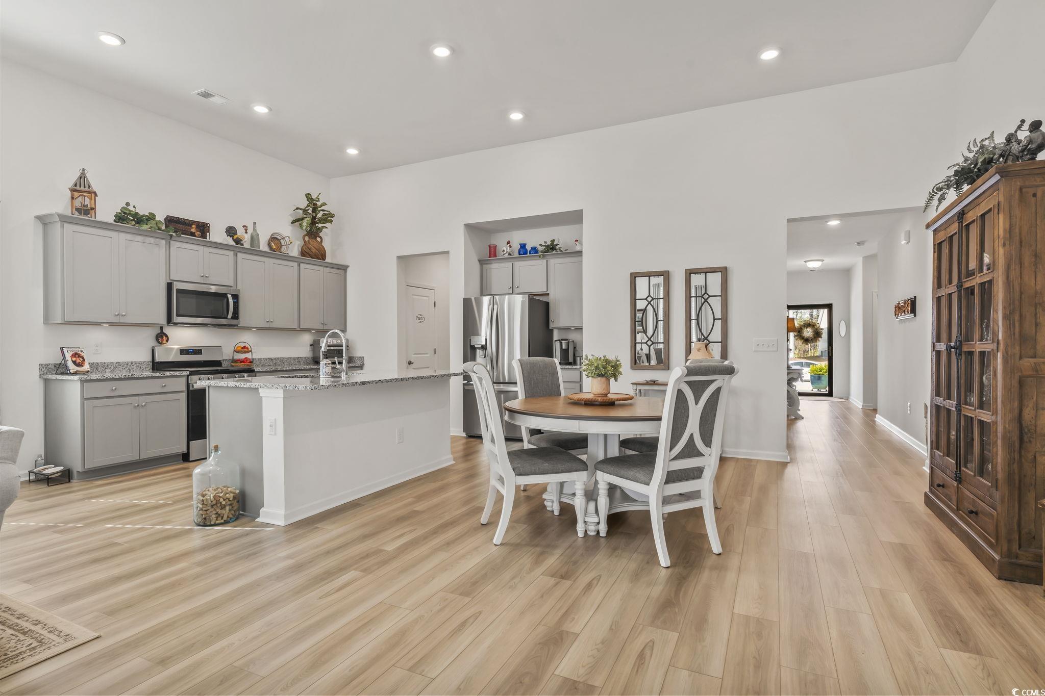 394 Sun Colony Boulevard Longs, SC 29568 - Photo 12 of 37 View showing breakfast bar seating and open layout to living room.