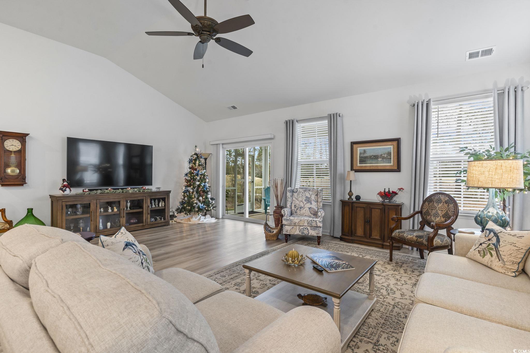 394 Sun Colony Boulevard Longs, SC 29568 - Photo 17 of 40 Shows the view of the backyard and golf course visible from the main living space through the 6 foot high windows