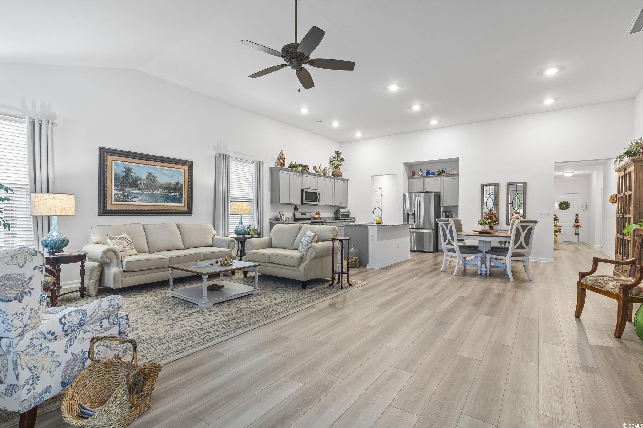 394 Sun Colony Boulevard Longs, SC 29568 - Photo 18 of 40 Captures the spacious feel with seamless transition into kitchen and dining areas
