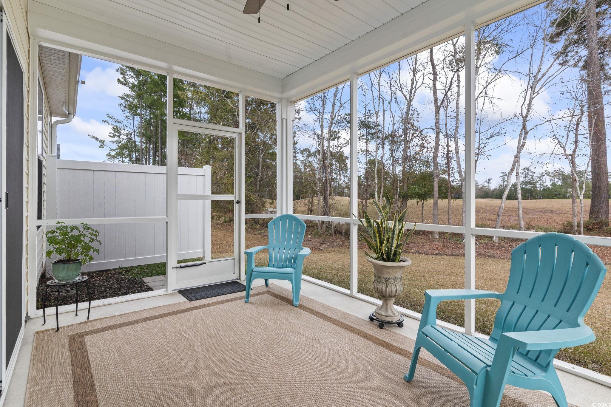 394 Sun Colony Boulevard Longs, SC 29568 - Photo 29 of 40 Screened outdoor living space with ceiling fan and views of the golf course and 14th hole