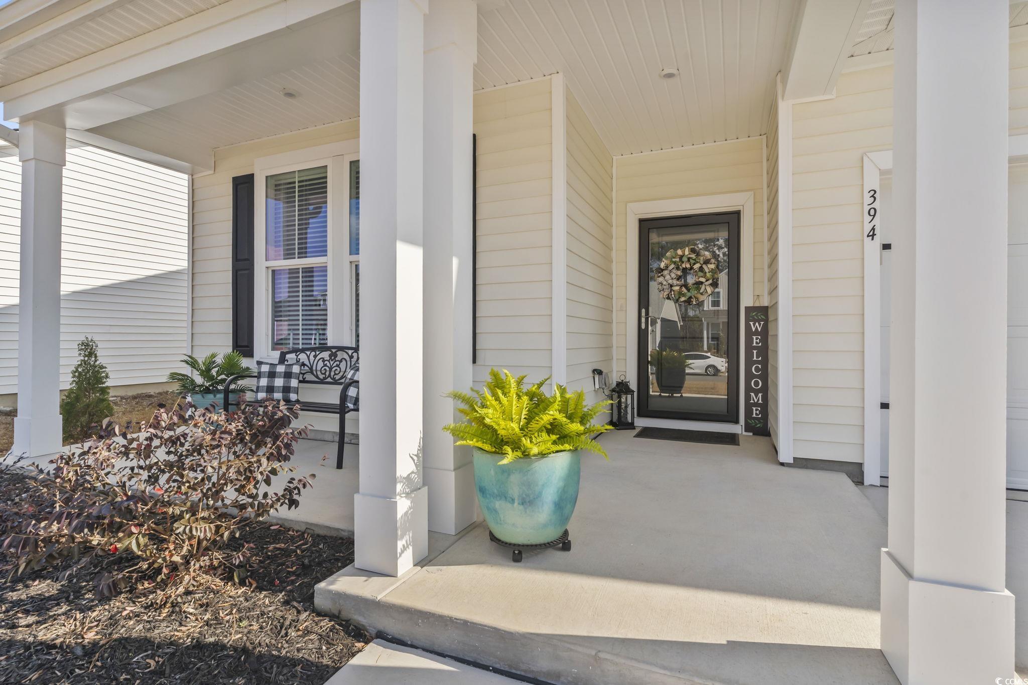 394 Sun Colony Boulevard Longs, SC 29568 - Photo 33 of 37 Spacious covered porch with room for seating; upgraded overhang unique to this Chelsea model