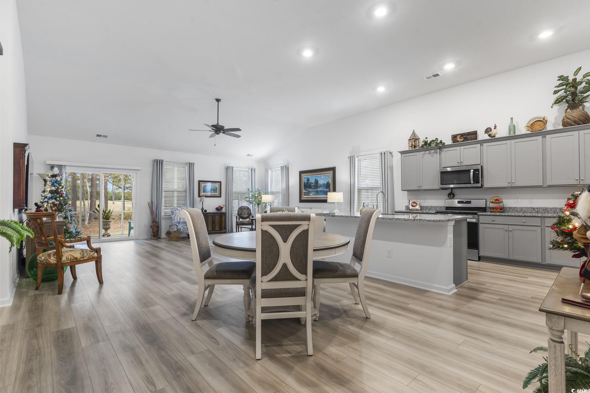 394 Sun Colony Boulevard Longs, SC 29568 - Photo 6 of 40 Dining space adjacent to the kitchen with upgraded lighting and window treatments