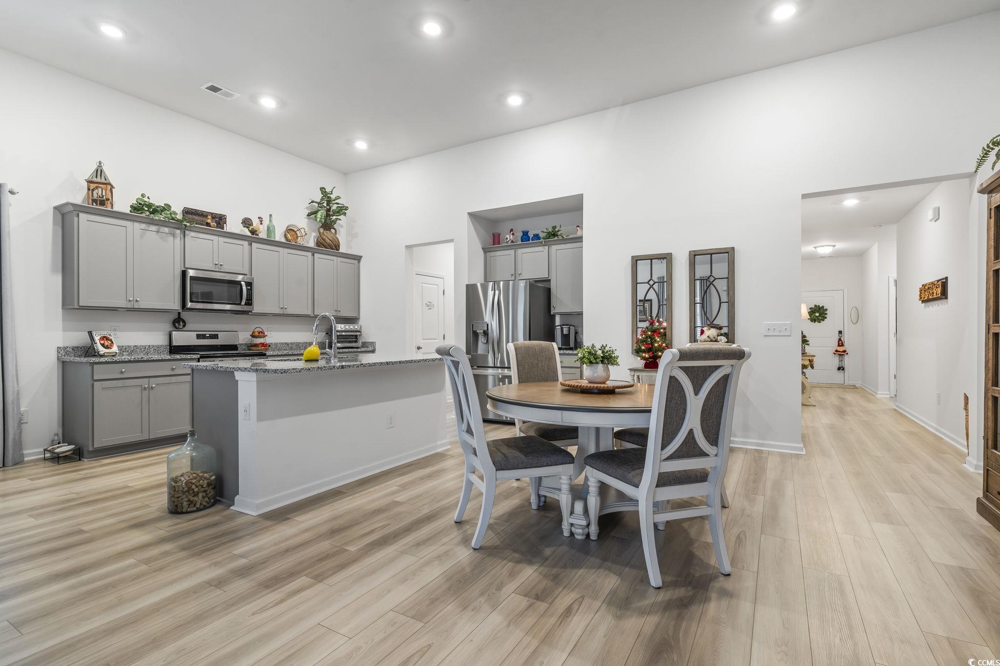 394 Sun Colony Boulevard Longs, SC 29568 - Photo 9 of 40 View showing breakfast bar seating and open layout to living room.