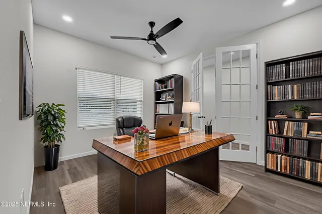 a view of an empty room with wooden floor